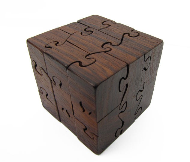 A sublime little puzzle cube of solid rosewood designed by Lis + Kjell Drewsen.  Retains original box.  Purchased from Copenhagen showroom of note, Den Permanente, c. 1962