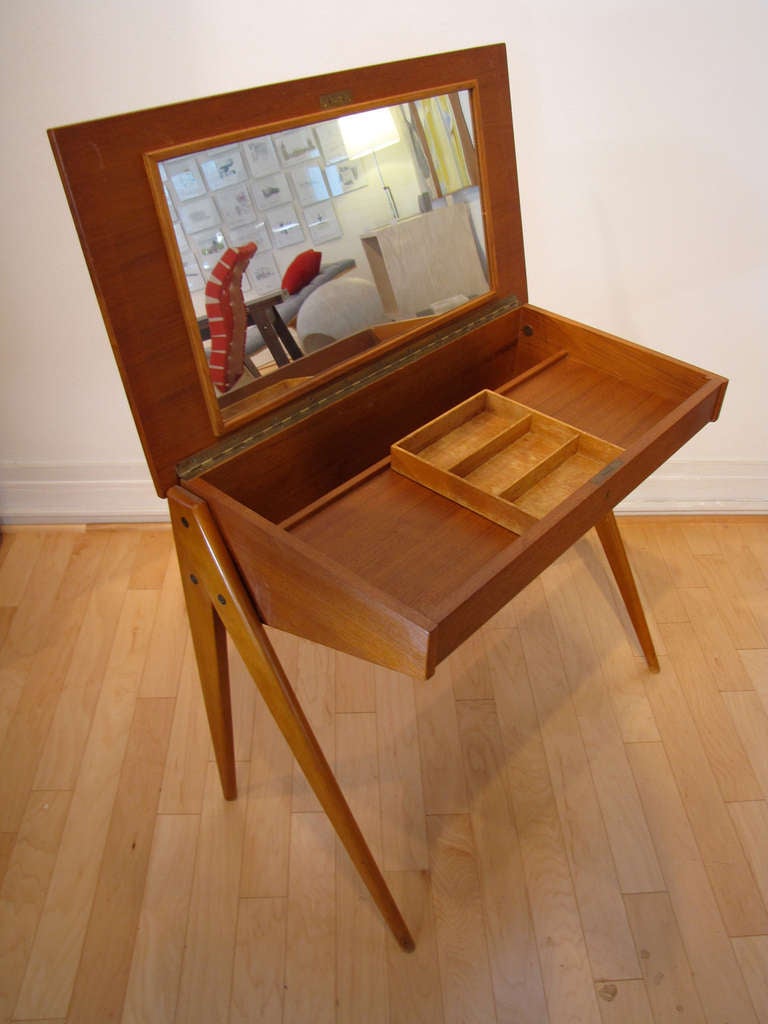 Vintage Danish or Swedish Compass leg desk/vanity in teak with fold up lid.  Interior compartment reveals ample storage and sliding tray.