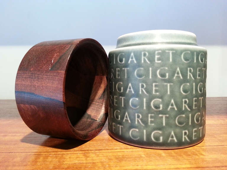 Vintage stoneware cigarette humidor in Kronjyden's relief series by Jens Quistgaard with solid rosewood lid.  Exterior marked with repeating word 
