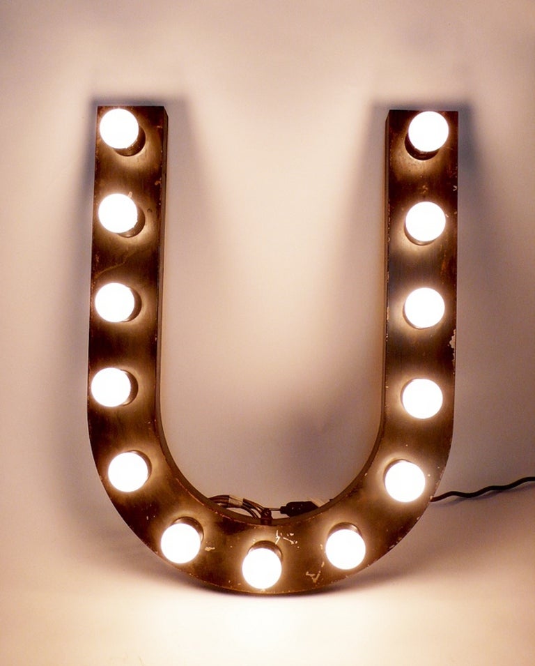 Painted tin letters, black color, rewired with bulbs, used for a theatre sign.