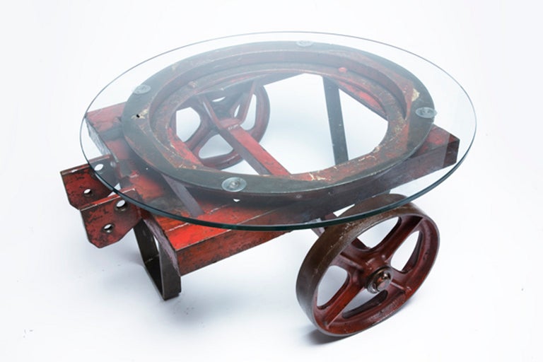 Rare painted iron, red color, industrial cart with a rotating round glass base and 2 wheels.