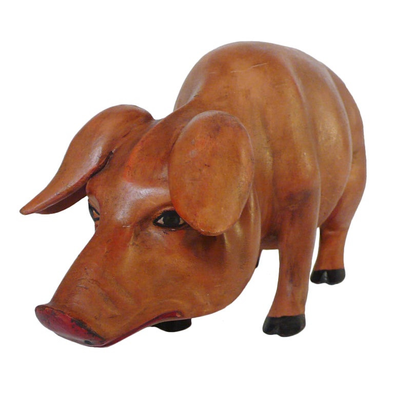A Carved Wooden Sculpture Depicting A Pig.