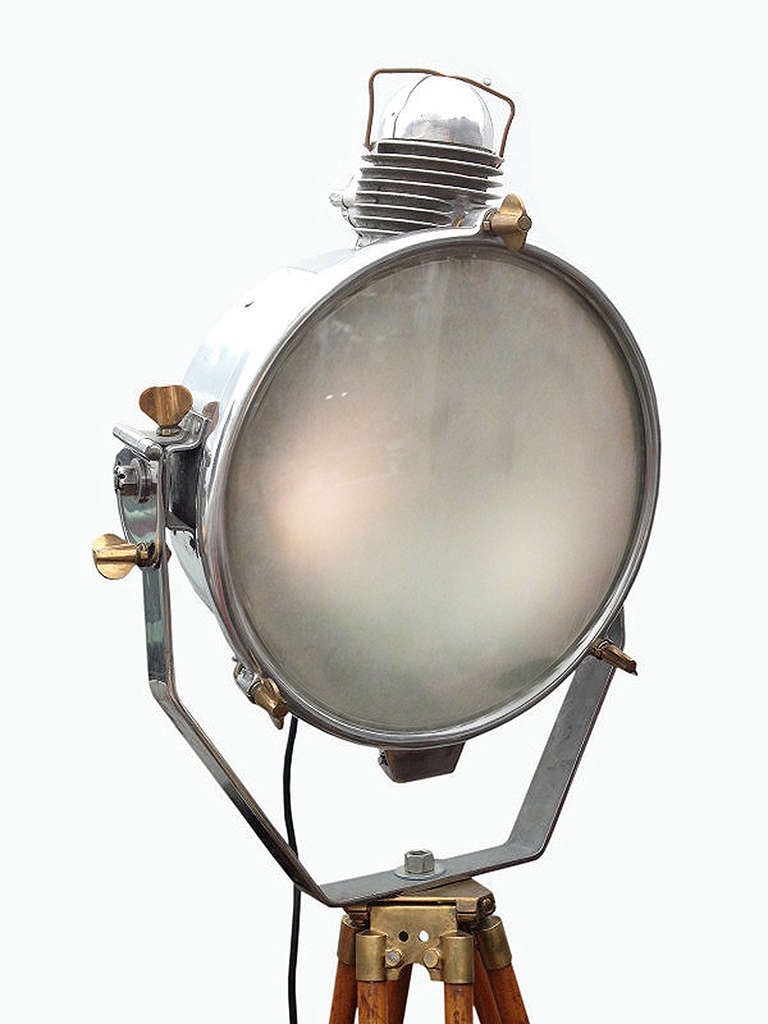 A fine example of reutilization of an old locomotive headlight from a Pennsylvania Train. Converted in a chromed metal floodlight with adjustable wooden tripod and aluminium feet.