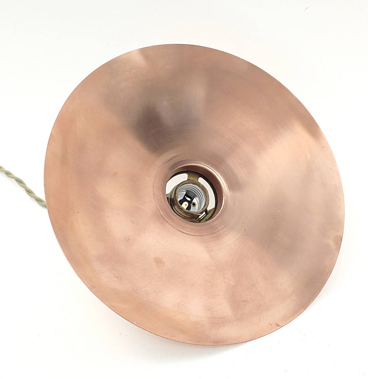 German hanging lamps of different diameters, made of copper in the shape of circular plate with connection for the bulb and switch  made out of brass. Braided fabric wire. Sold separately for $ 450,00 each.