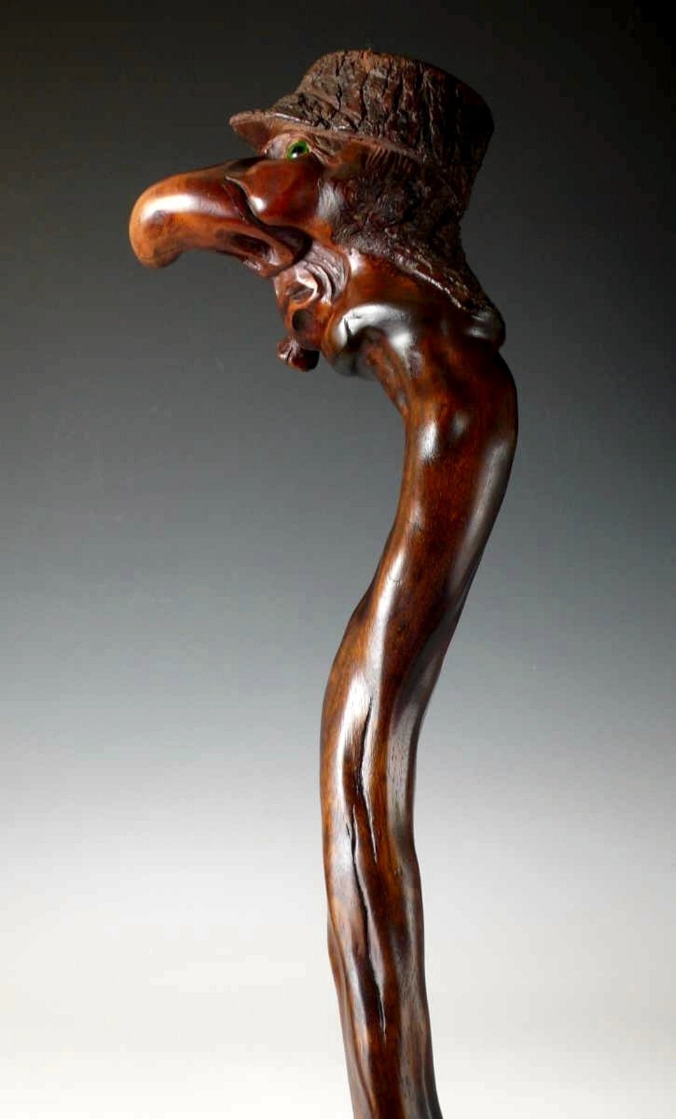 A Carved And Stained Wood Walking Stick.