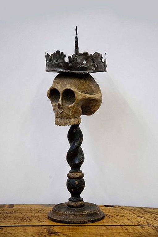 An important and rare Memento Mori candleholder. The round base with moved profile is carved out of fruitwood and clear color, as well as the foot, that rise with a vase shaped element , black, than a ring, clear color, and the final black twisted