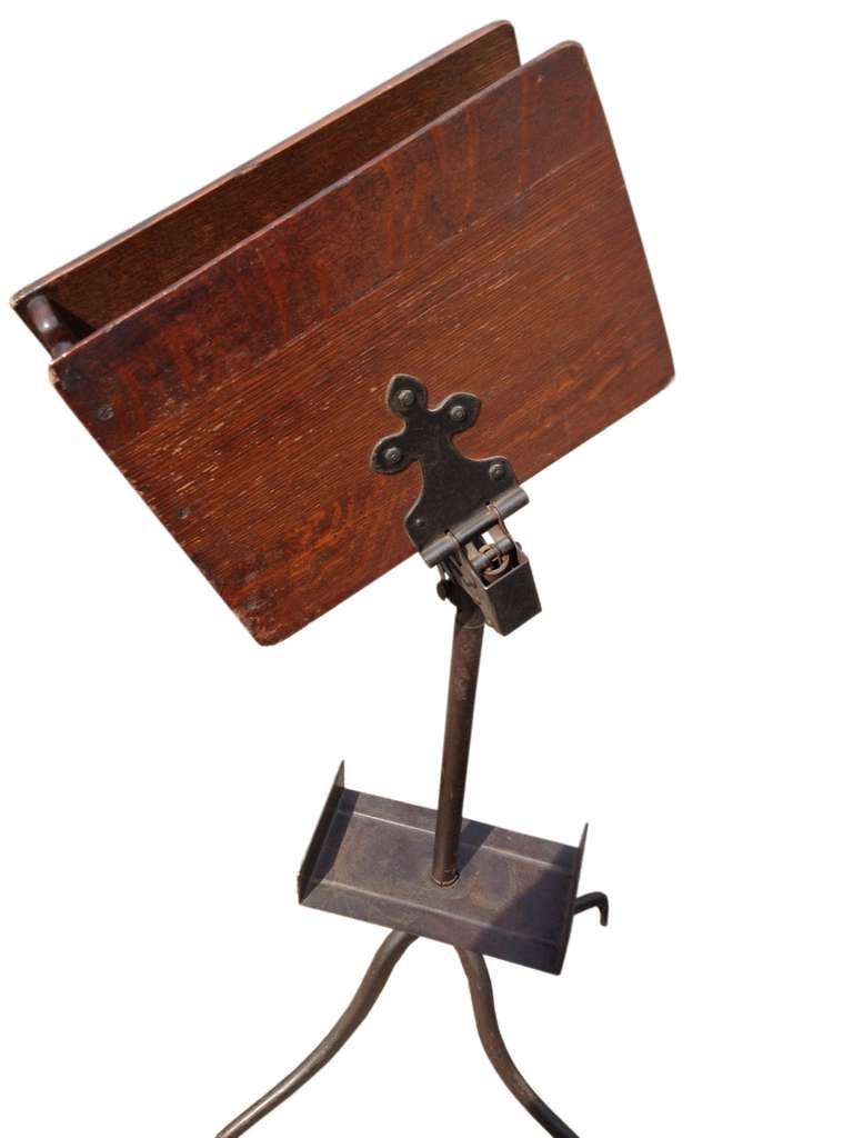 A music score holder. American 1912, made out of oak wood and iron, with tripod legs.