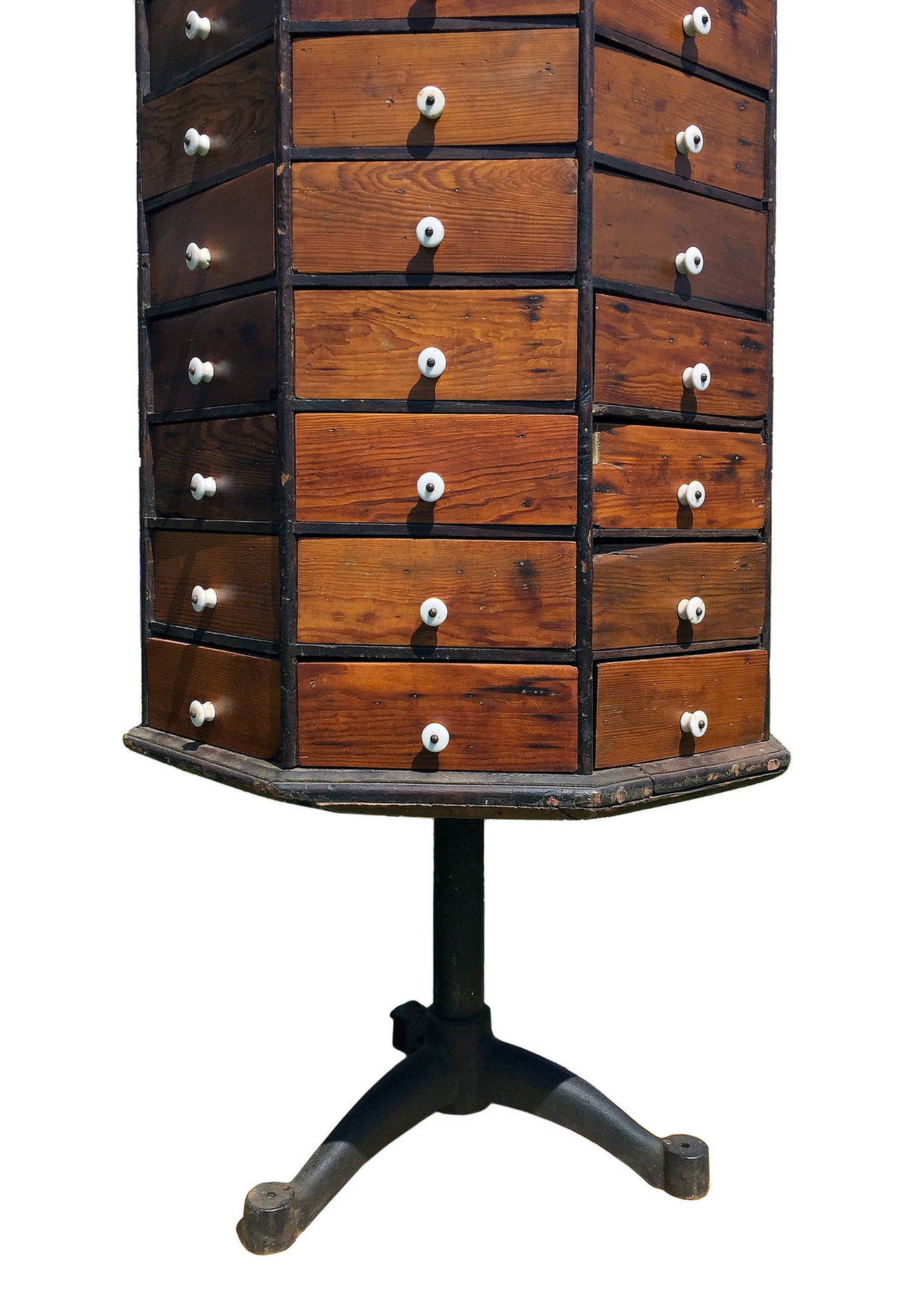 A rare and unusual spinning , revolving chest of drawers octagonal shape made out of oak and mahogany wood with eighty little drawers  , with white porcelain knobs.