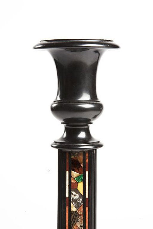 A rare pair of italian Grand Tour candesticks, on a square base, made out of absolut black marble and encrusted on each side of the stick with a wide selection of marbles and pietradura such malachite and agathe of different kind. Italy