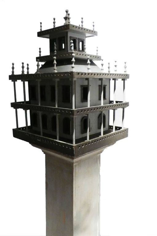 Painted wooden birds house with square wooden plinth.