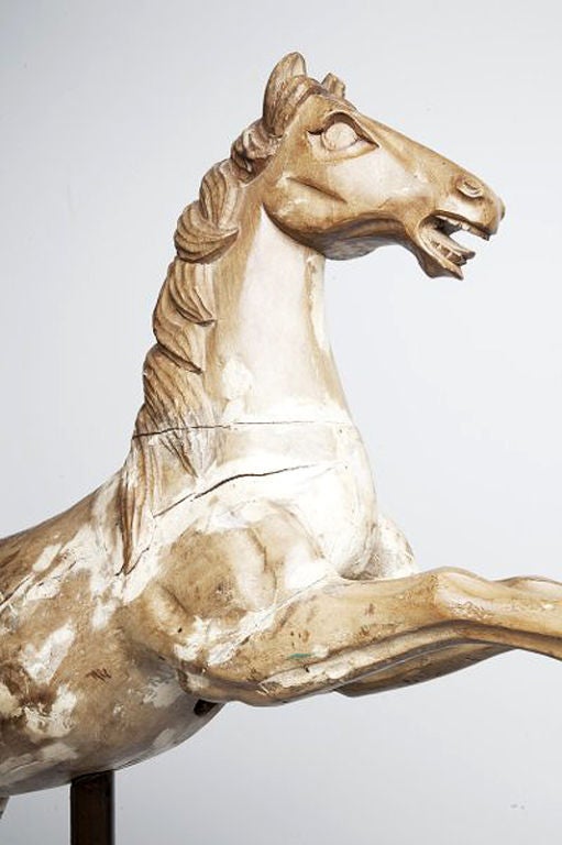 An extremely rare Italian wooden sculpture of a rampant carrousel horse. 1780 ca. Superb quality of sculpting and engraving. Modern metal base. Measure refers to the horse only.