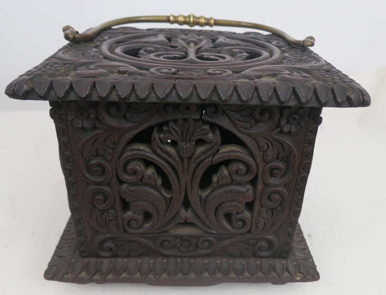 Oak carriage warmer, with carved imagery including lovebirds, grapes, tulips, foliate decoration a sunflower on the bottom. carved date 1749 with initials P.J. Forged brass handle, twisted form with acorn finials