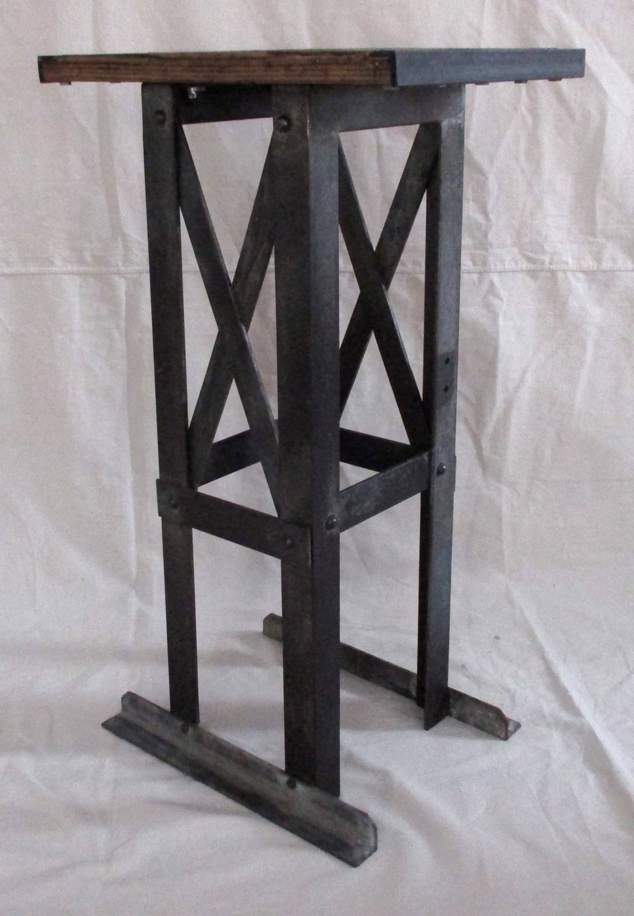 Mid Century industrial pedestal made of steel with a replaced vintage wood top.