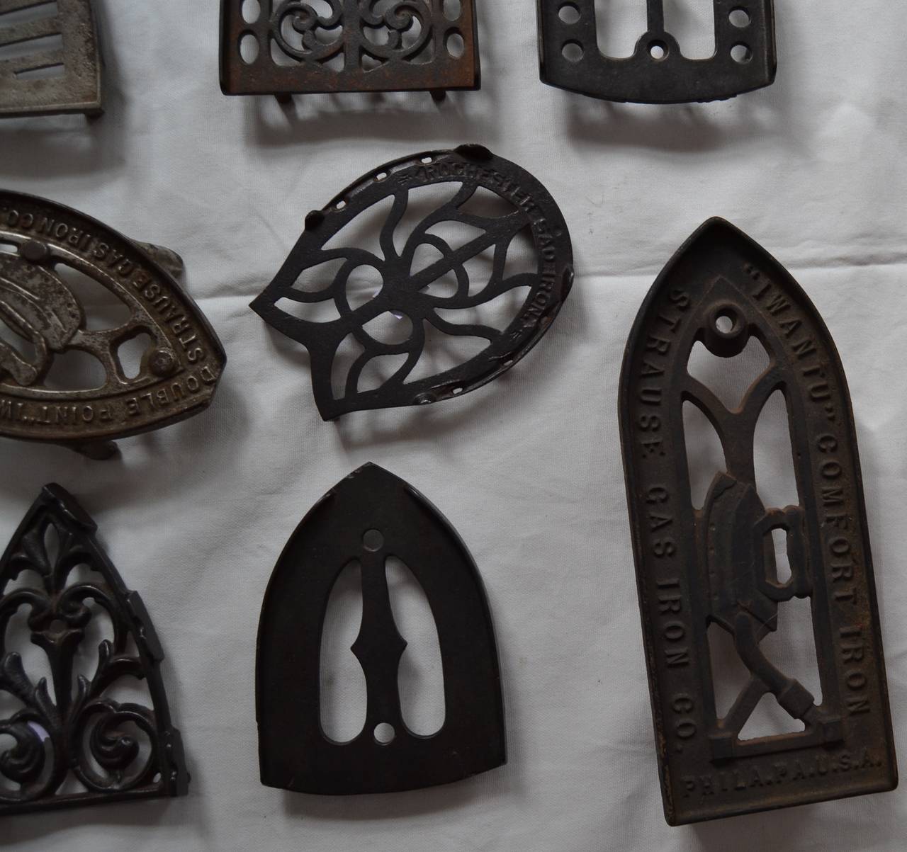 Cast Ten Sad Iron Trivets For Sale