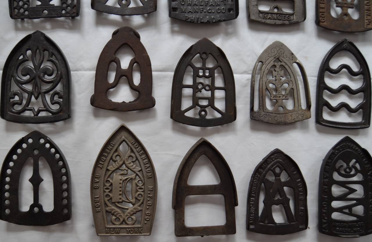 Cast Collection of Sad Iron Trivets For Sale