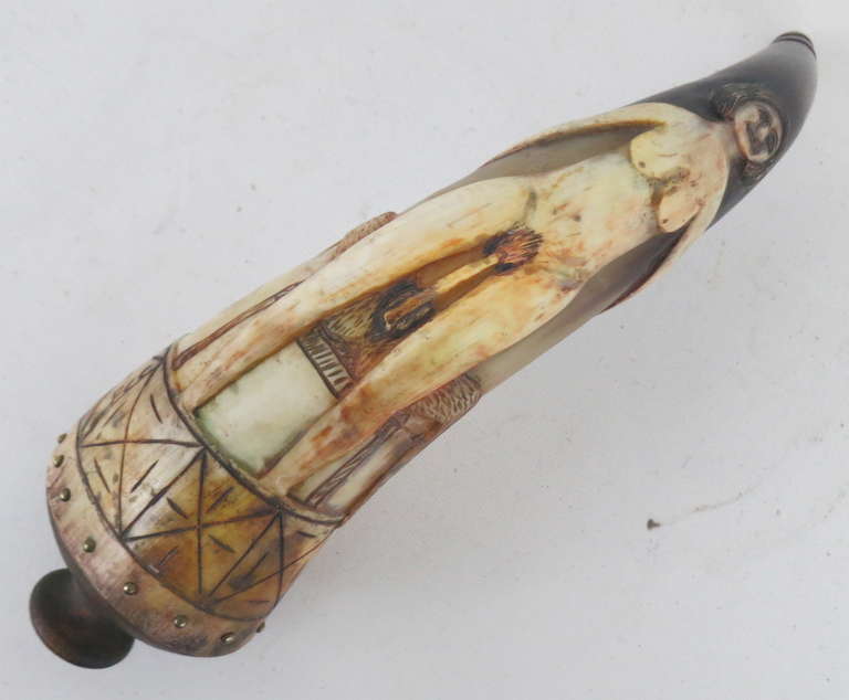 An early 20th C. erotic carving on a powder horn, initialed PCC, brass rivets