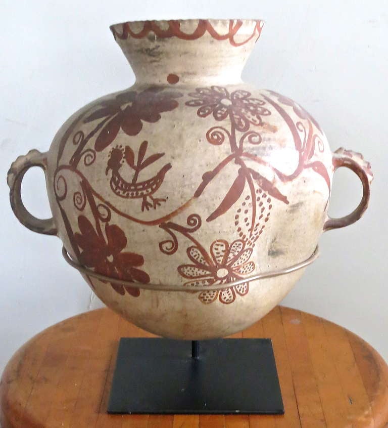 Measures: 12.5 inch tall. Late 19th century paint decorated Mexican pot on a custom iron museum mount.