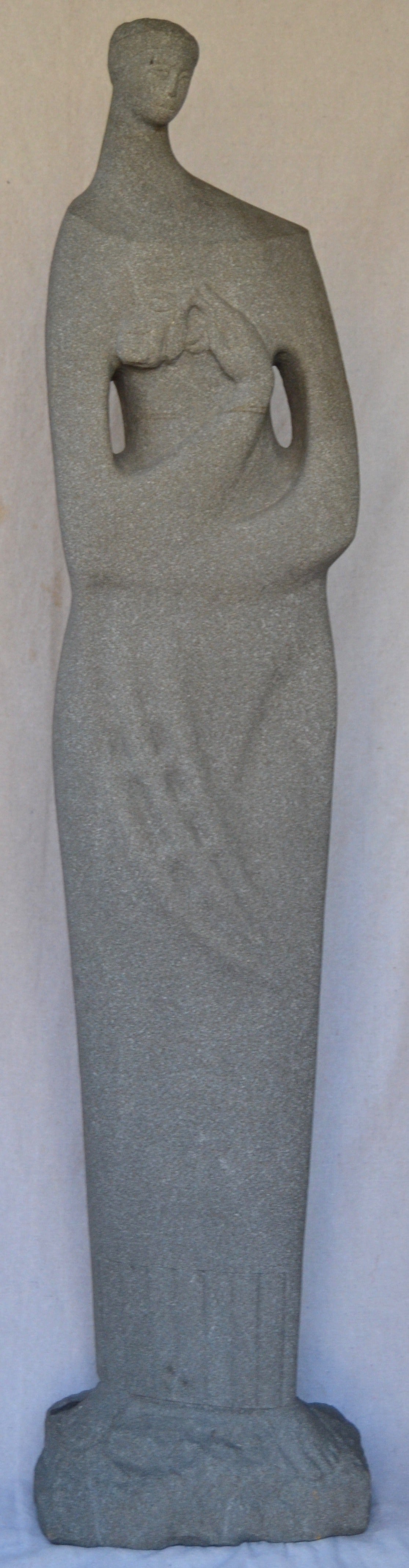 Stylish carved granite sculpture of a woman holding a flower. Simple elegant lines, signed Kurek, 1967.