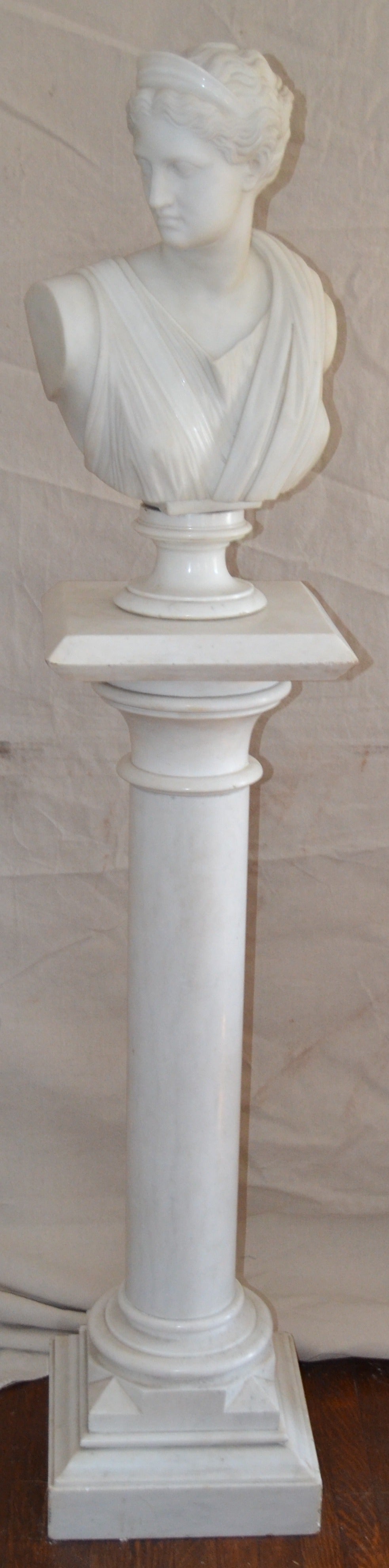 Well executed white marble bust of the goddess, Diana, on the associated pedestal. After the antique, Diana is 24 inches high including socle, pedestal is 44.5 inches high and 13 x 13 inches.