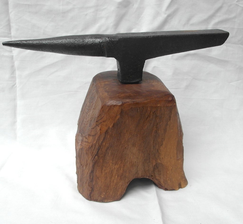 Handsome mid-19th century stake anvil mounted on a wooden stump, sculptural form with elongated horn.
