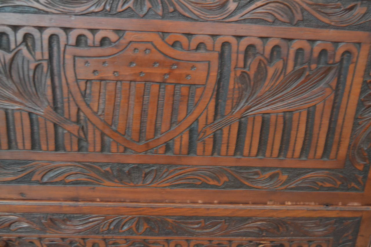 One drawer pine blanket chest with all-over carving, 13 star shield motif, exuberant carved leaves, cut-out feet. Mellow old varnished surface, possibly original but may have been polished at some point in its life. Rare example of patriotic