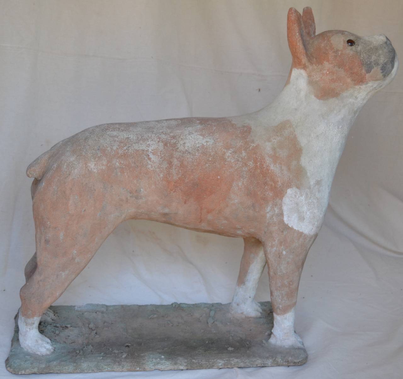 Charming expressive concrete sculpture of a Boxer dog. The concrete is modeled over a wire armature with glass eyes. The gesture of this dogs head makes you just want to lean over and pat him. Nice weathered color and texture.