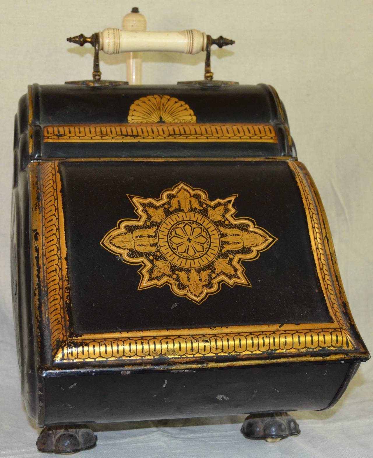 Victorian gilt decorated coal hod with unusual porcelain faux ivory handles and casters. Great example of mid Victorian functional design