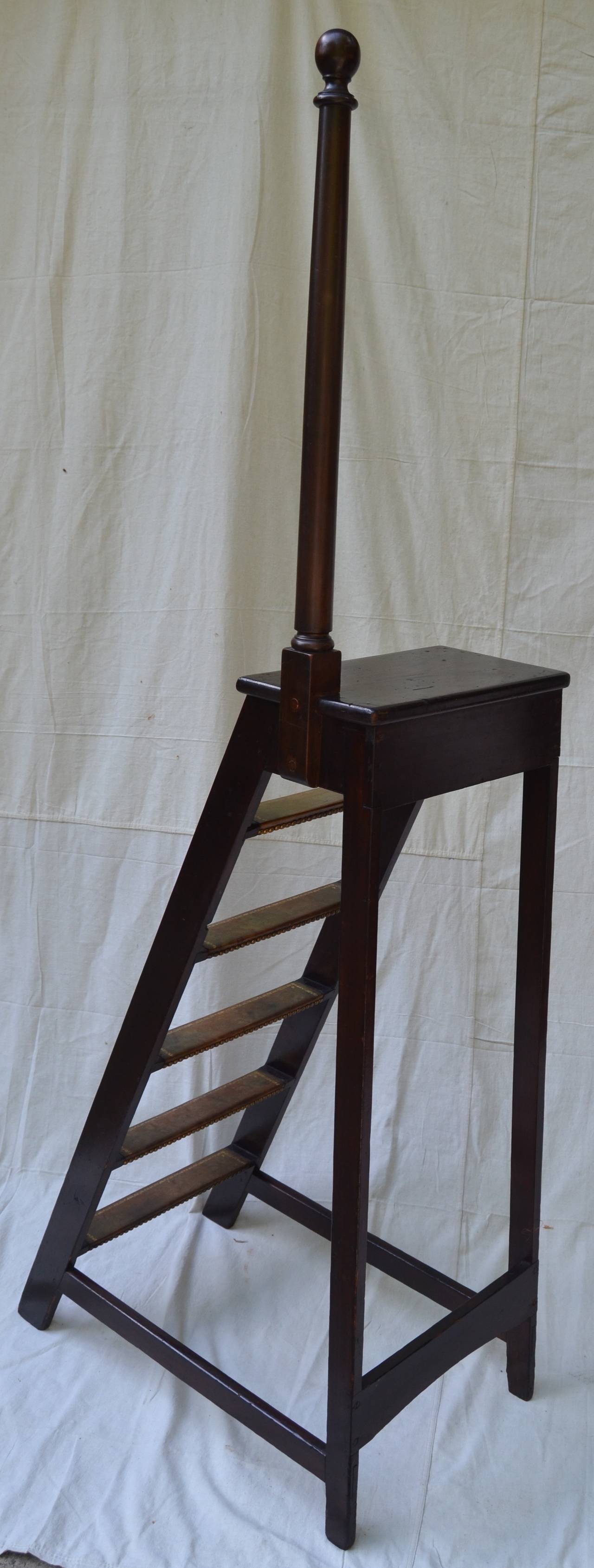 tall stained pine and leather library ladder, height of ladder is 48 in. overall height is 76 in. Light weight with sturdy mortised and pin construction, brass tacks add a handsome detail.