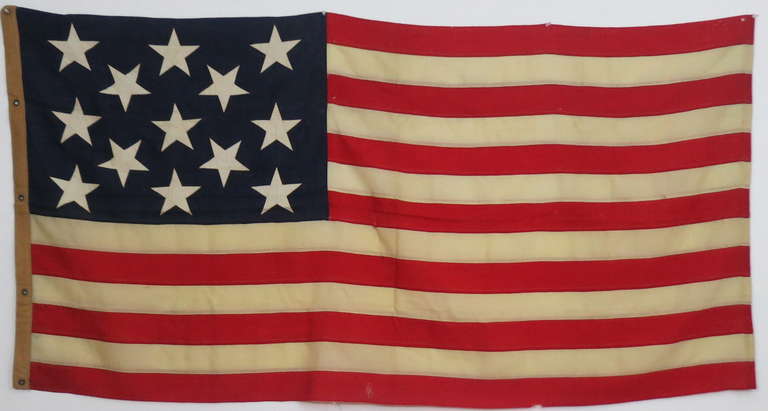 13 star naval flag of sewn wool bunting flag with beautiful bright colors and large graphic stars. The coarse heavy linen sleeve has stenciled on it's sleeve 