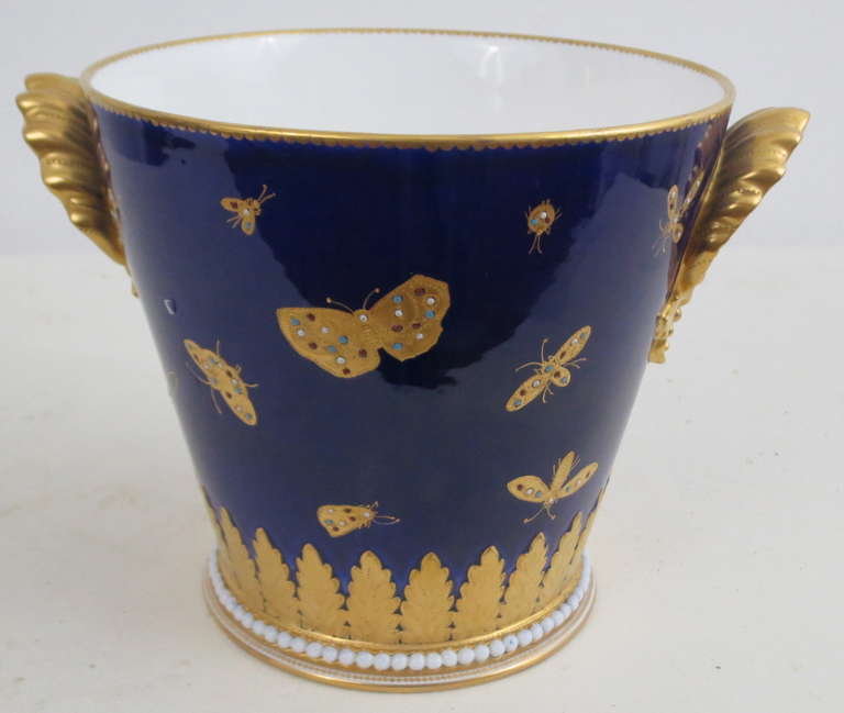 Cobalt Blue with Gilt and jeweled enamel  insect decoration, shell handles, and white beading around base. unmarked but is assumed to be English