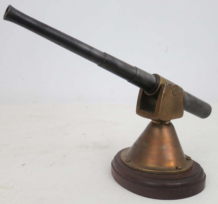 Paper weight size model of a naval artillery cannon made of brass and steel. Stamped 