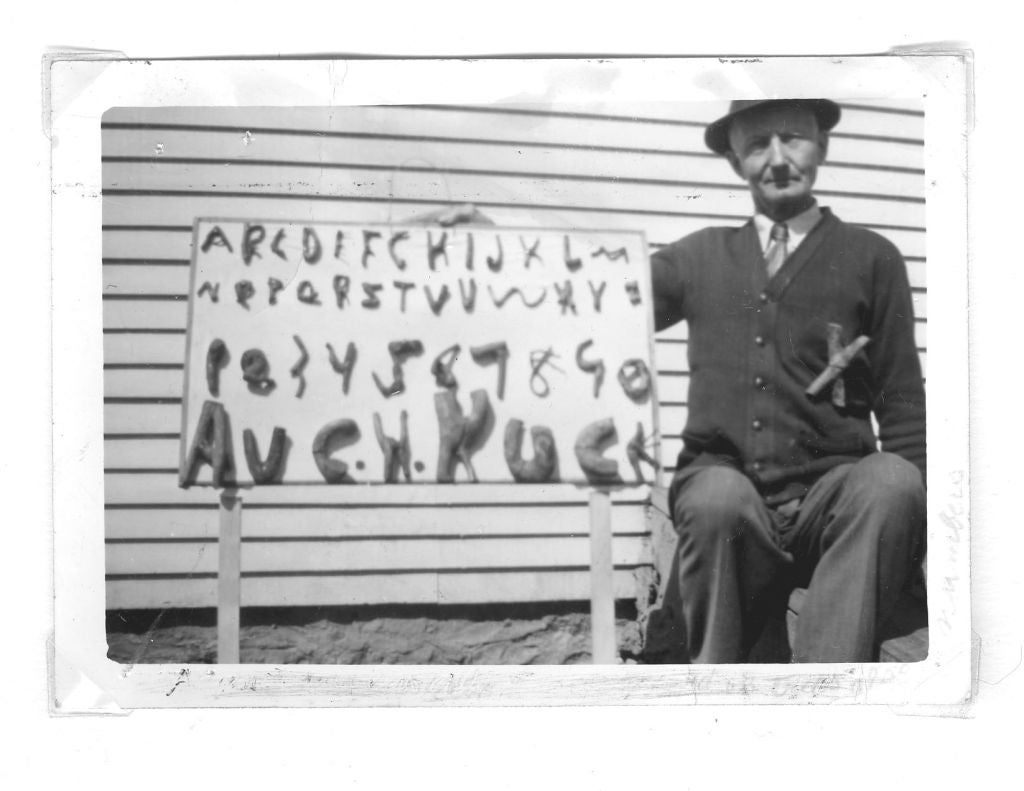 Extraordinary American Folk Art board composed of the alphabet made from branches trained into the letter forms. Found in Southern Kentucky dates to 1940s. An accompanying vintage snapshot shows the artist with another of his works and wearing an