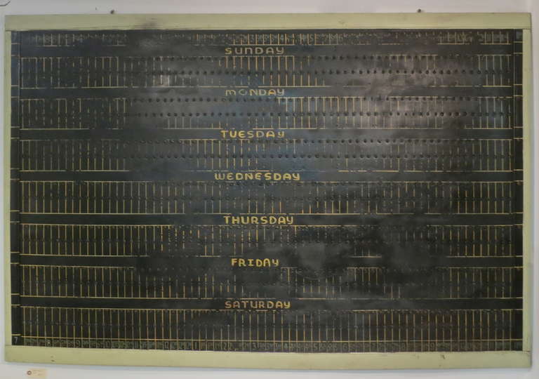 Large hand-painted board used in a depression era radio station for programing. Each 15 minute time slot of the day has a small hook which was used for slotting the playtimes in the pre-computer era.  Has a very contemporary  graphic appeal with