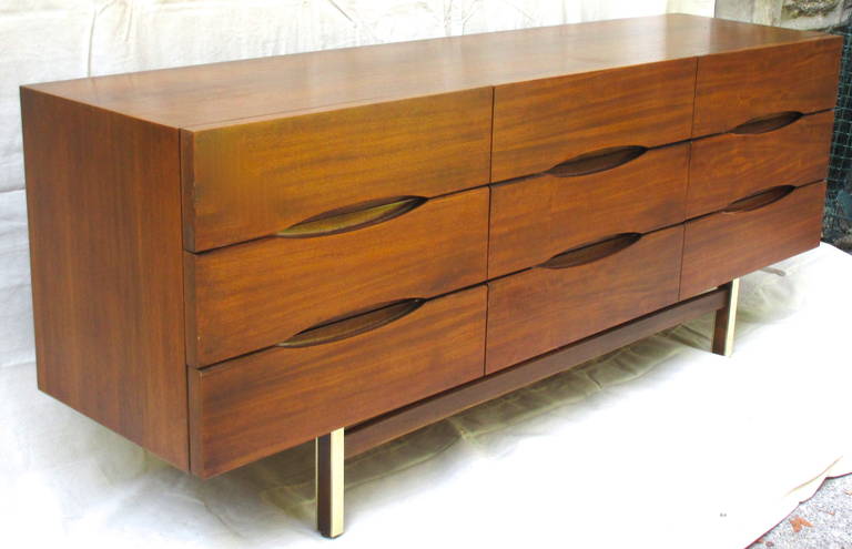 Handsome Mid-Century nine-drawer chest by American of Martinsville. Great graphic elliptical cut-outs forming the drawer pulls. Nicely scaled in the original finish.