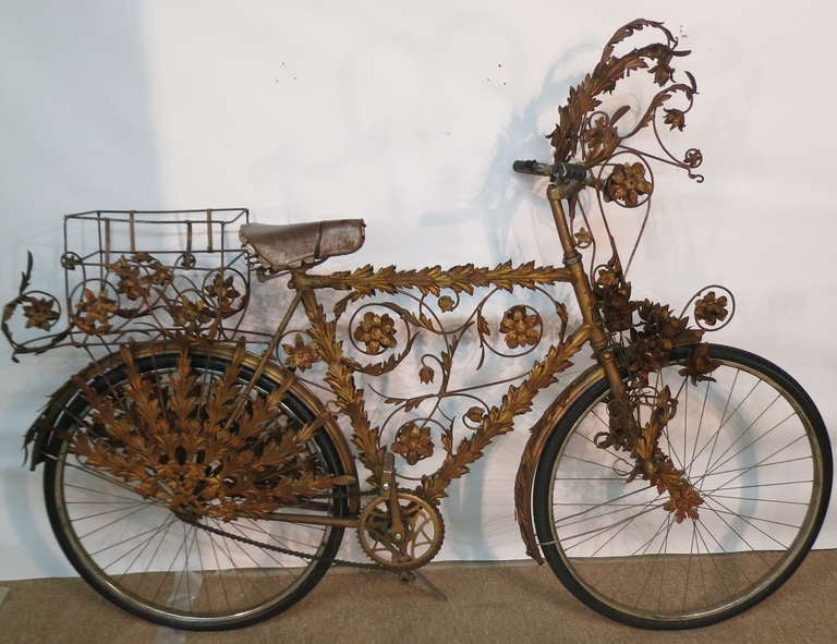 Elaborate and sculptural bicycle with ornate gilt iron floral and leaf ironwork. Used as a prop in the original 1973 London stage production of 