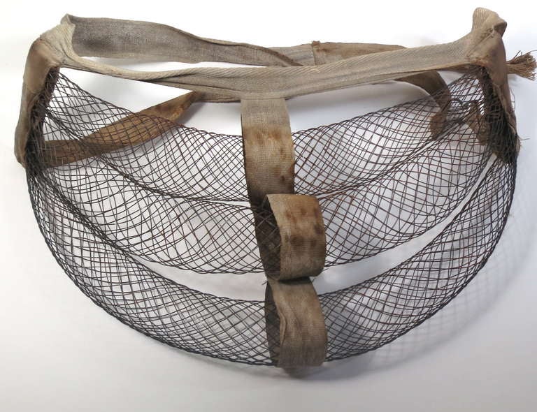 Victorian wire bustle to add form to the rear of a dress. Made of three rows of shaped wire and cotton tape. This undergarment has an especially pleasing sculptural form.
