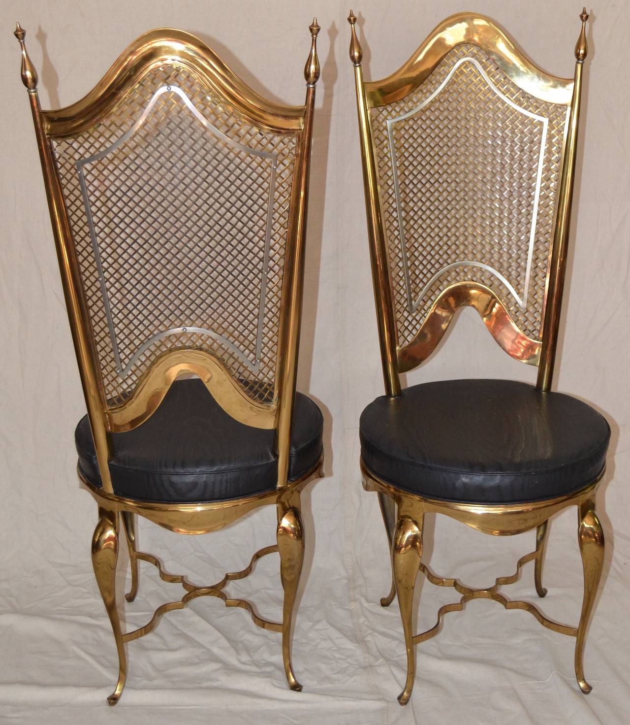 Heavy cast brass accent chairs with decorative applied steel, unusual and interesting form. Brass faux caning and shield shaped steel, exaggerated finials, arabesques brass stretchers. Original watermarked moire upholstery, upholstery label