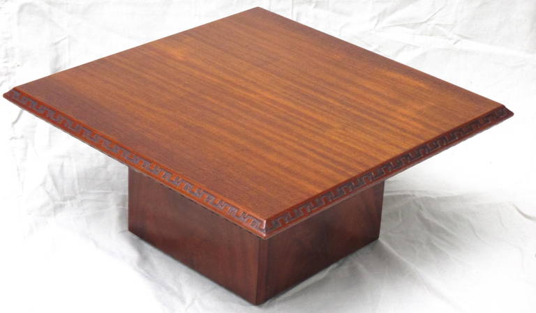 Frank Lloyd Wright Mahogany table with Taliesin design carved on edge.  Stamped FLW monogram in red.