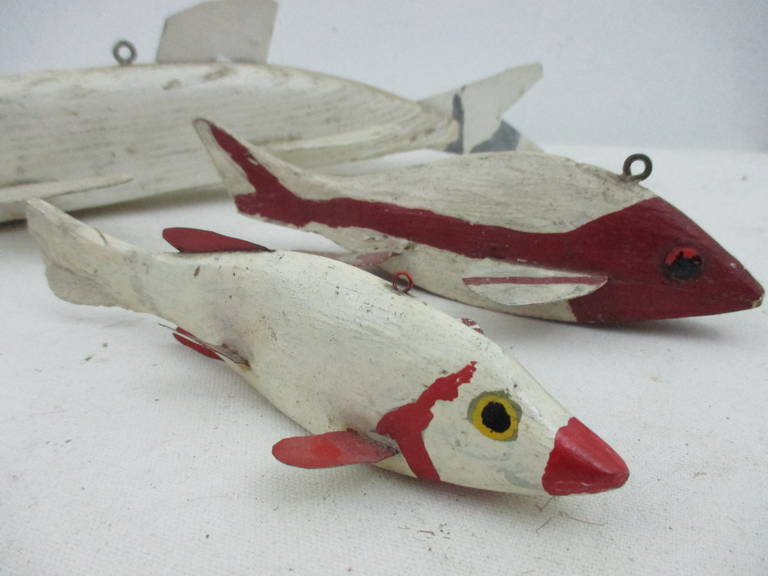 10 wonderfully graphic 20th century ice fishing decoys.
2 with wooden tails, ranging in size from 14
