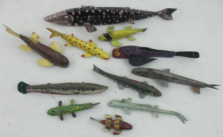 A collection of 10 ice fishing decoys. whimsically painted  and carved these range in length from 13