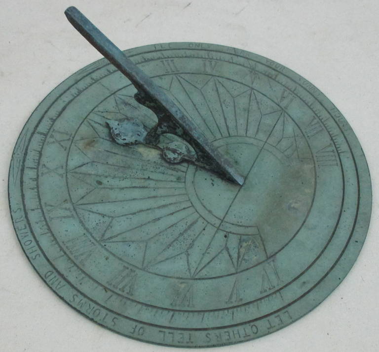 A bronze sundial with the motto 