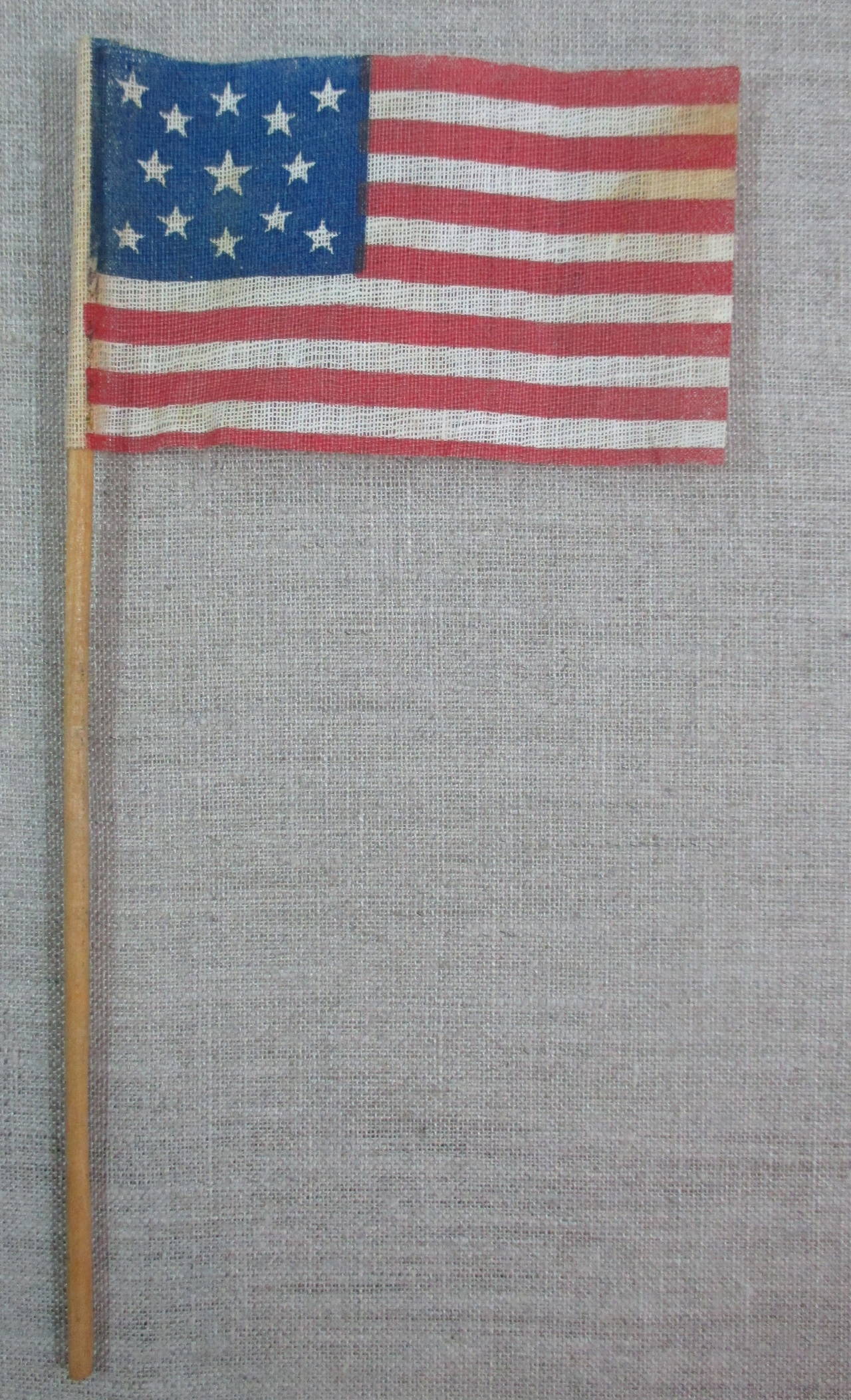 Parade flag printed on coarse glazed cotton for the American Centennial celebrations in 1876. This is the larger size which is much harder to find than the smaller size parade flag. Flag measures: 2 3/8