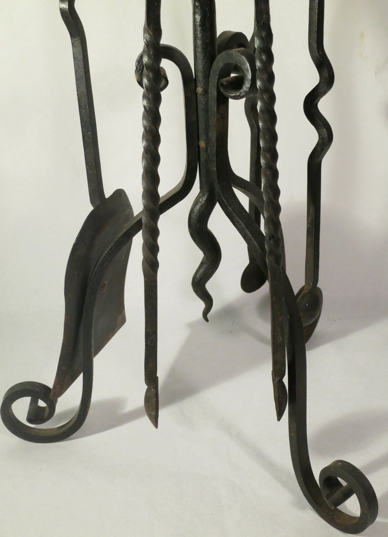 Curvaceous set of late 19th C. hand wrought iron fire tools.  Lively form with great detailing.