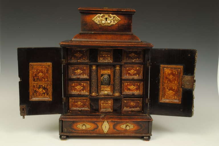 A rare example of a 17th century Flemish cabinet with leather covered drawer fronts, which have gilt tooling.