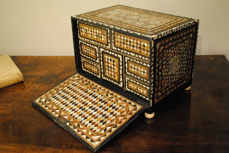 A fine and rare sixteenth/ early seventeenth Ottoman table cabinet the whole decorated with geometric designs in mother of pearl and tortoiseshell, the fall front opening to reveal a fitted interior. 

Provenance: Private Lincolnshire collection 