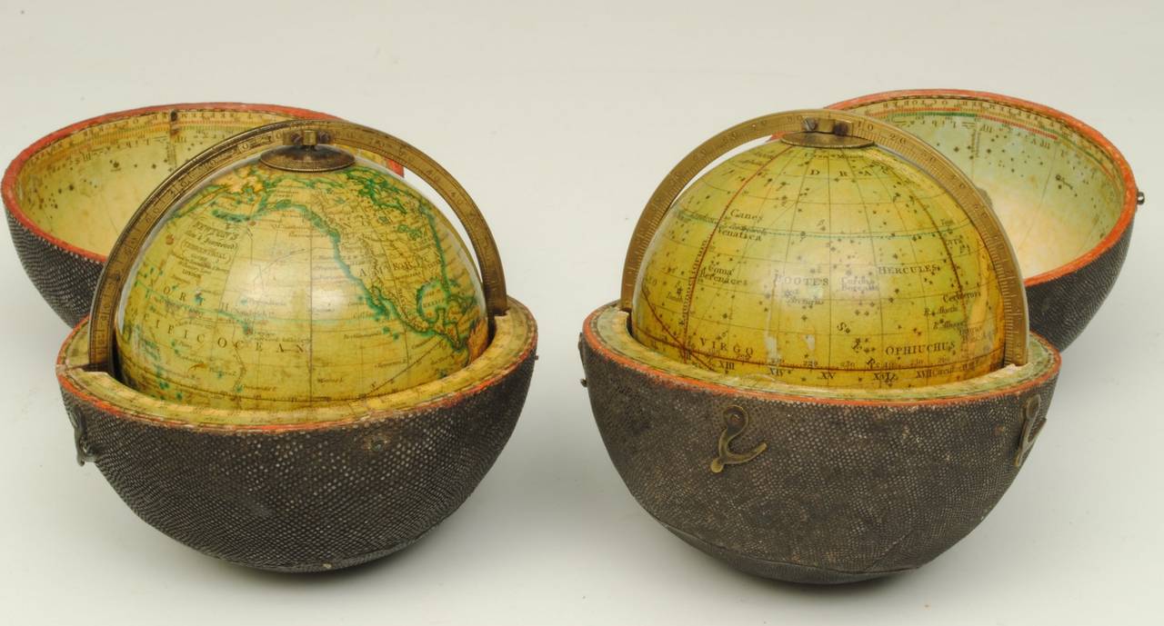 A fine pair of early 19th century pocket globes contained in the original black fish skin case with an engraved brass meridian. This pair of globes retain the original varnish and are both in unrestored condition.