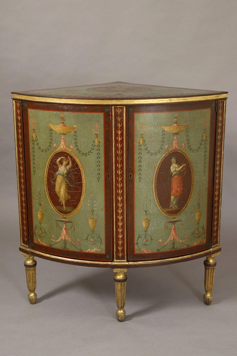 A fine painted and gilded bow fronted corner cabinet probably by Henry Clay. The top and doors with Angelica Kauffman style decoration . Henry Clay took out a patent in 1772 for a 'new improved paper ware ' , this involved pasting together a number