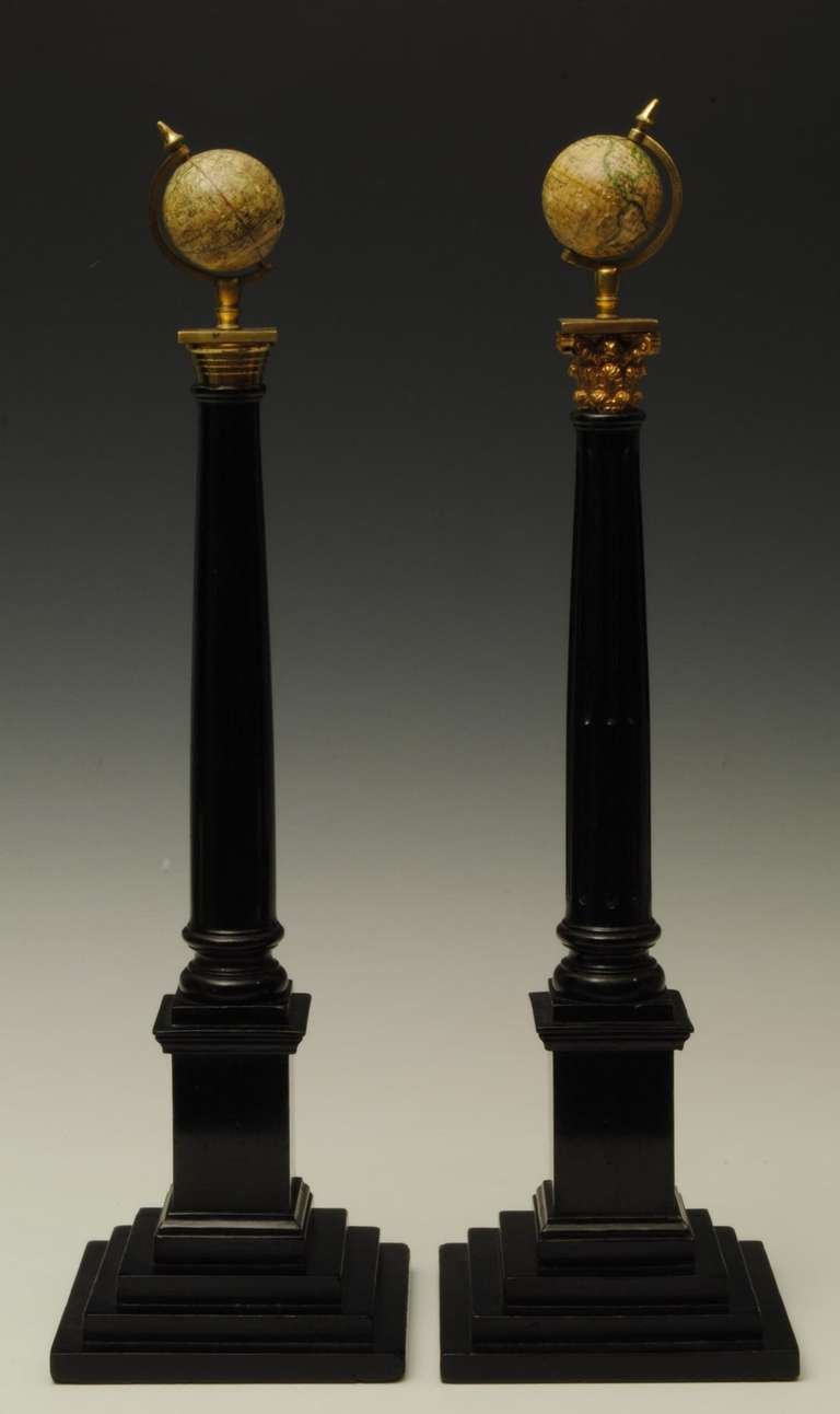 A decorative pair of terrestrial and celestrial globes mounted on a corthian and ionic column with ormolu mounts. These globes are often found on friendly socity trade cards.
The globes are by Smith, London and with a makers label of Spencer, London