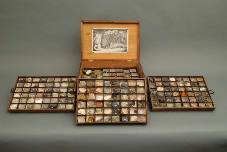 An interesting collection of rocks and minerals contained in a wooden case with brass handles and feet. The four trays containing various samples each in a small box and with a hand written description