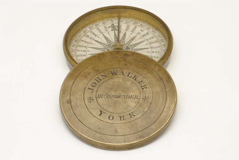 A 19th century pocket compass with the owners name engraved on the cover.